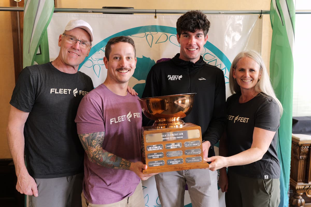 Group photo of fleet feet holding the corporate cup trophy